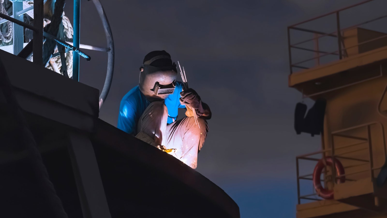 Welder working on ship at night Welder working on ship at night